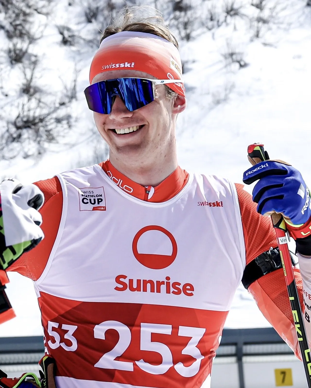 Vince Vogel laughing at the shooting range, with poles and race suit